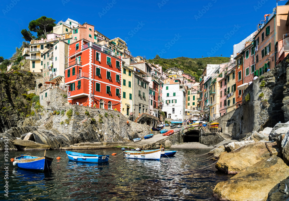 Riomaggiore village on cliff rocks and sea