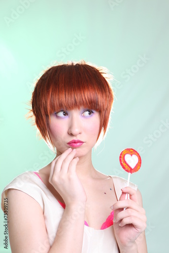 Young seductive woman with candy heart card for valentine's day