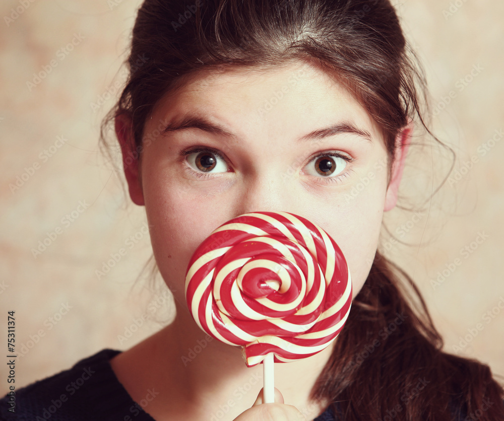 beautiful preteen girl with round candy