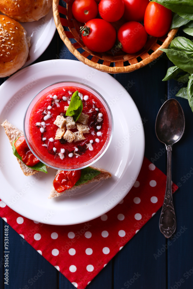 Gazpacho soup in glass bowl, on color wooden background Gazpacho soup in glass bowl, on color wooden background