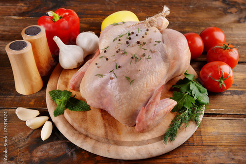 Raw chicken on wooden table