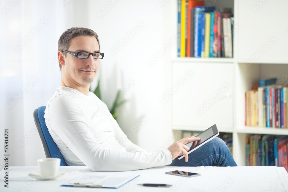 Smiling businessman using digital tablet 