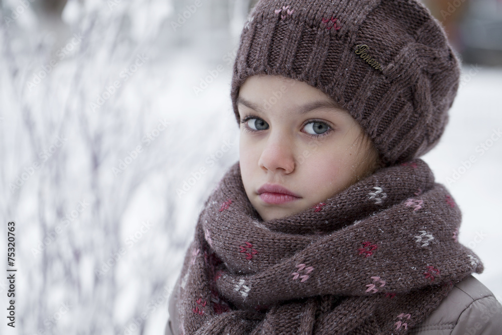 Happy little girl on the background of a winter park Happy little girl on the background of a winter park