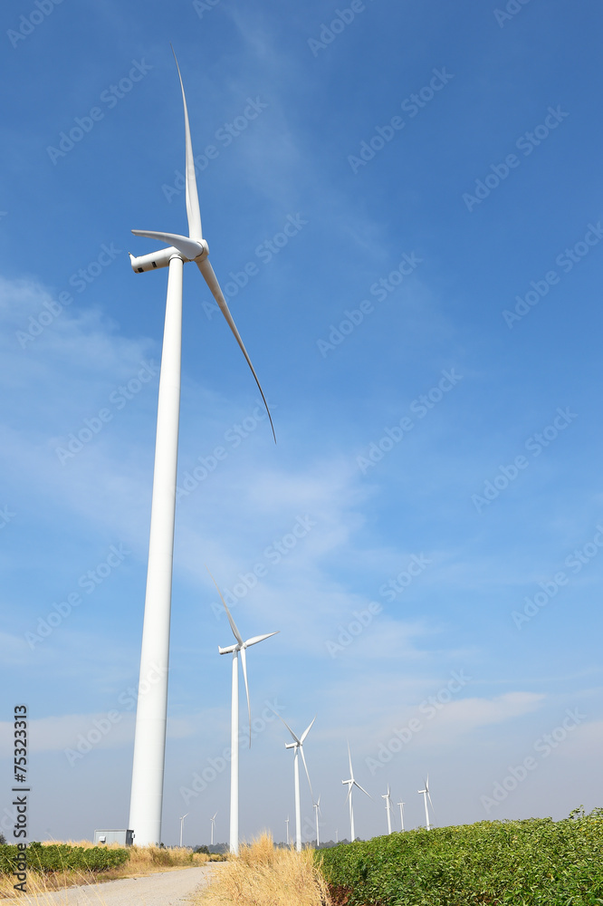 wind turbine against cloudy blue sky background