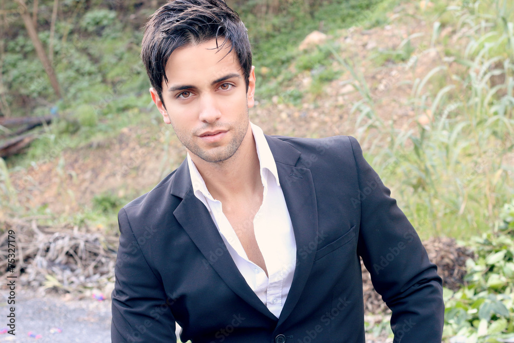 elegant man in suit sitting in the forest elegant man in suit sitting in the forest