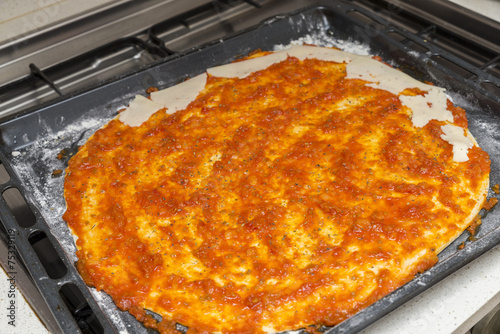 preparing the pizza dough with tomato
