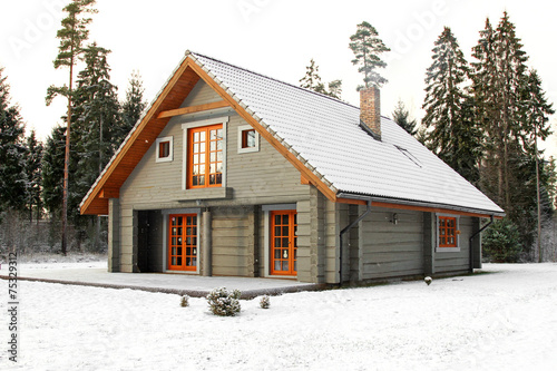 wooden snowy lodge in forest