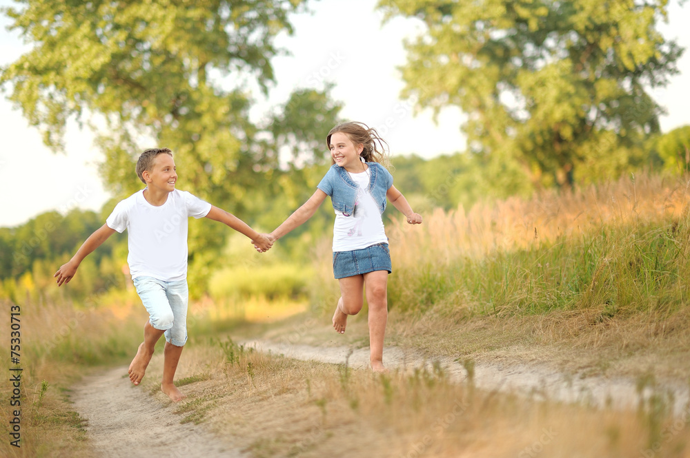 Portrait of a boy and girl on the field in summer Portrait of a boy and girl on the field in summer