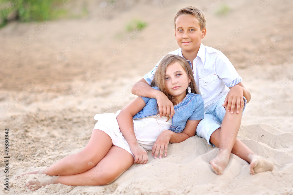 Portrait of a boy and girl on the field in summer