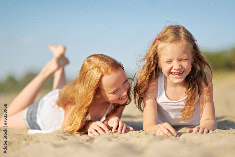 portrait of two sisters walking on the beach portrait of two sisters walking on the beach