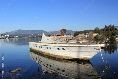 shipwrecked abandoned motor boat	 photo