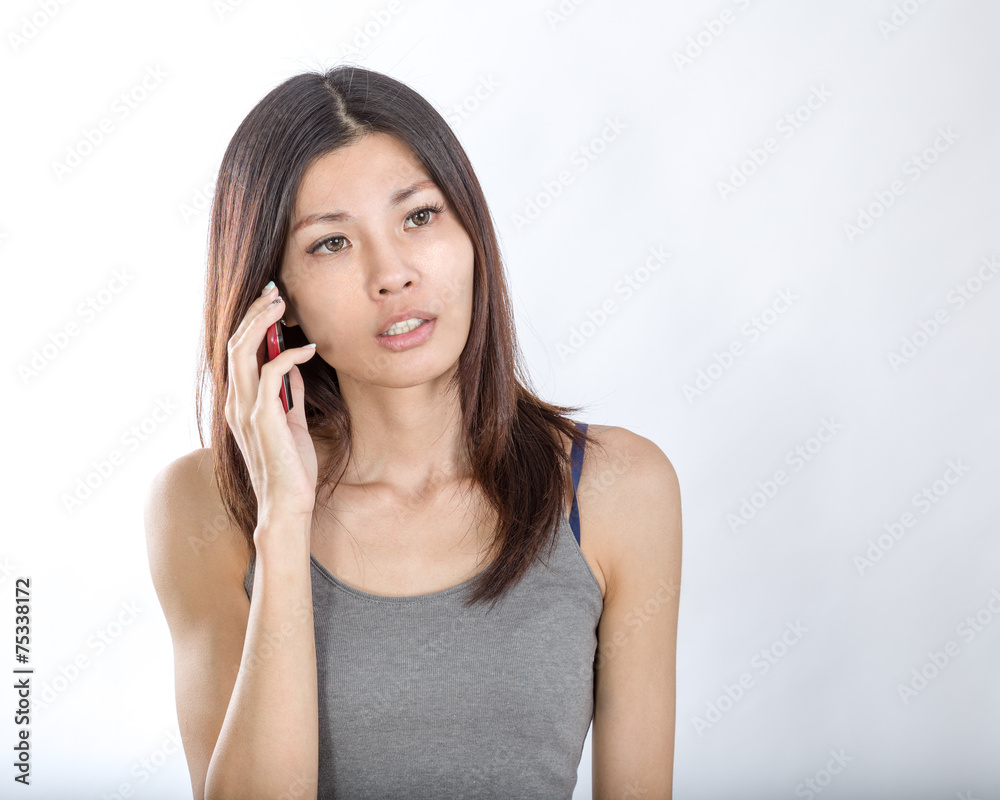 Asian woman talking on smartphone Asian woman talking on smartphone