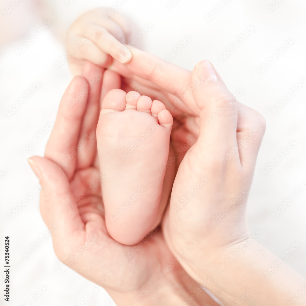 baby foot in mother's hands with care baby foot in mother's hands with care