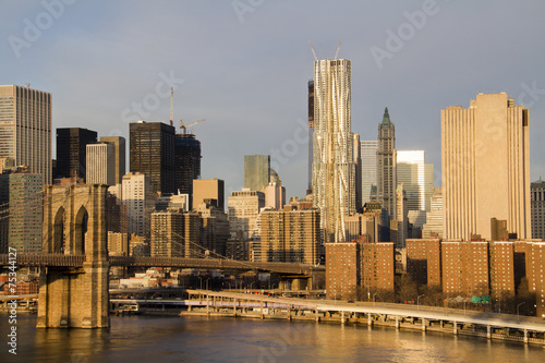 Lower Manhattan in the background of Brooklyn Bridge in a sunny morning, New York, United States