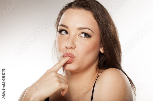 Fotografi young seductive woman sucking her finger