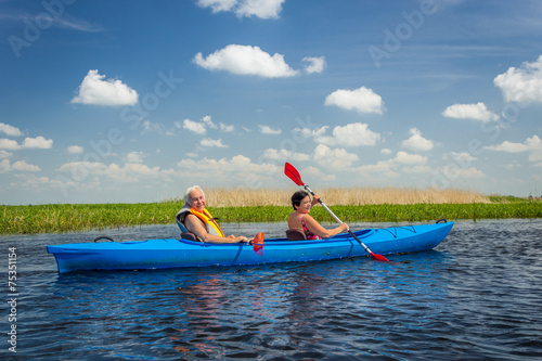 Couple kayaking on river photo