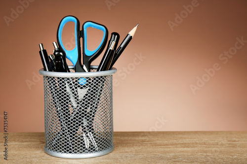 Metal holder with pens, pencil and scissor