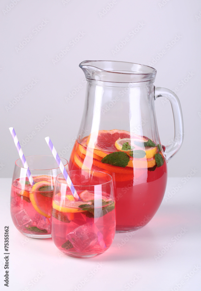 Pink lemonade in glasses and pitcher isolated on white Pink lemonade in glasses and pitcher isolated on white