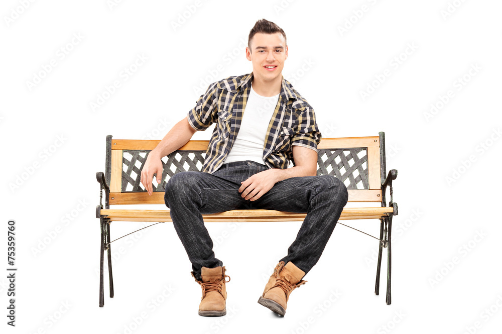 Cool young male model sitting on a bench