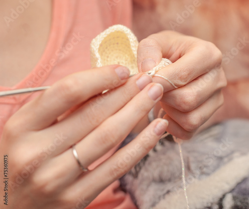 Close up of hands crocheting with wool
