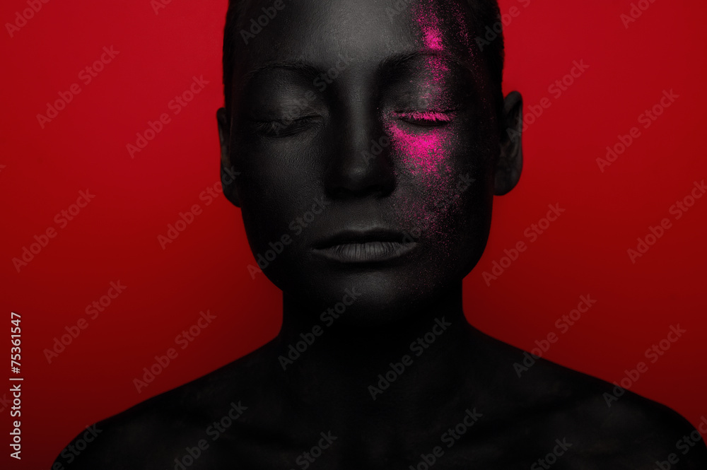 close-up portrait of woman in black paint