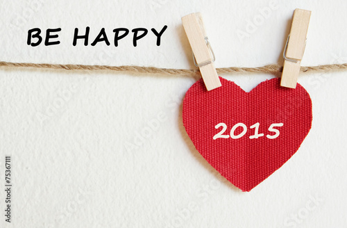Red fabric heart with happy new year 2015 word background