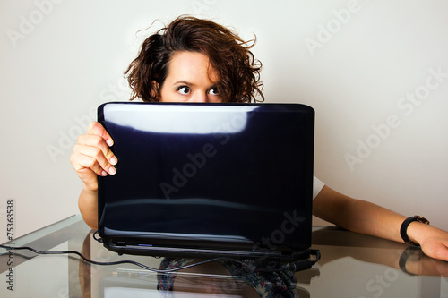 Scared woman sitting at her desk.