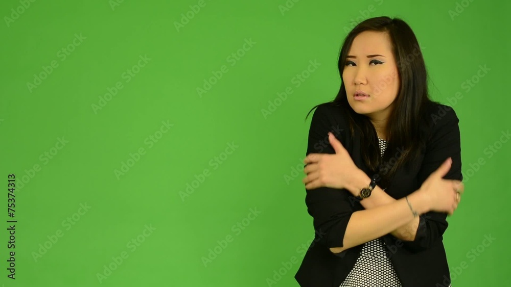 asian woman shivers - cold - green screen studio asian woman shivers - cold - green screen studio