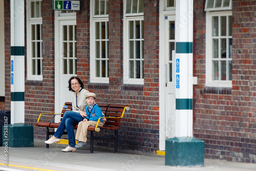 Young mother and son on railway station platform