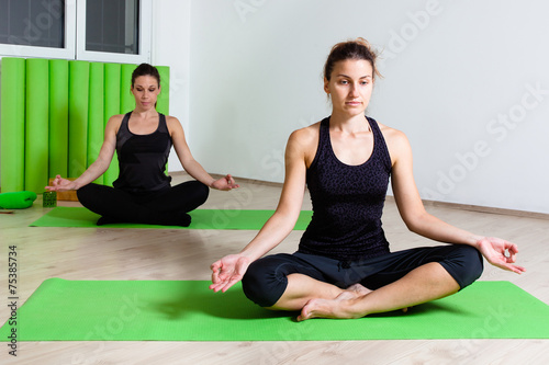 two girls in lotus position