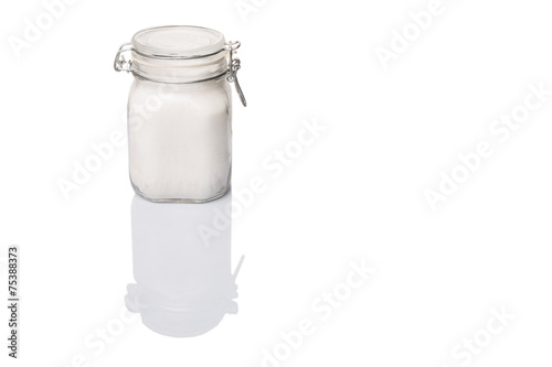 Granulated sugar in glass jar container 