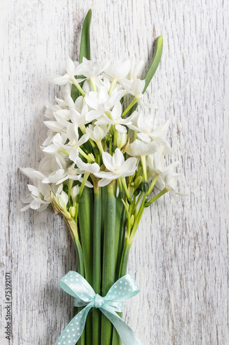 White narcissus flowers on wooden background