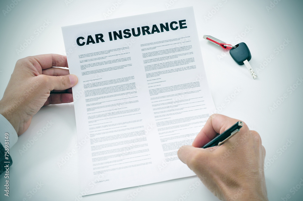 man signing a car insurance policy man signing a car insurance policy