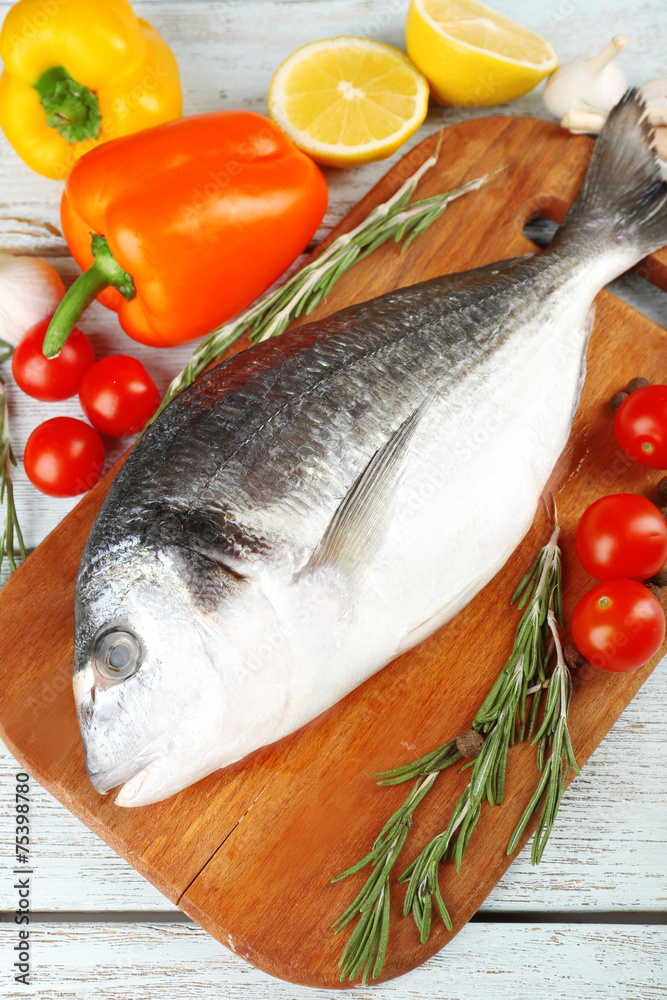 Fresh raw fish and food ingredients on table Fresh raw fish and food ingredients on table