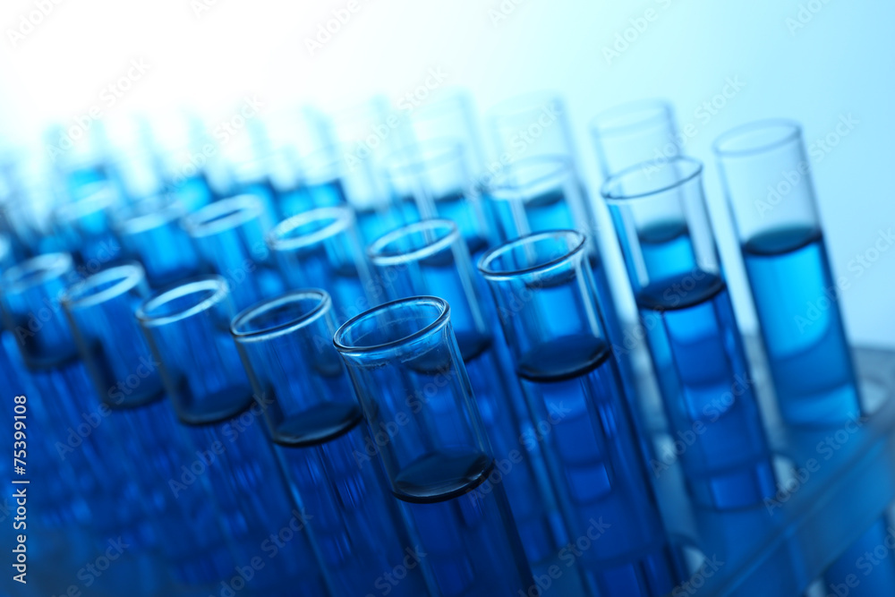 Blue water in a transparent test-tube on light background Blue water in a transparent test-tube on light background