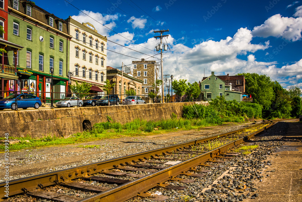 Fototapeta premium Railroad tracks and buildings on Main Street in Phillipsburg, Ne