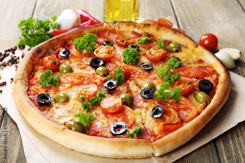 Tasty pizza with sausage, vegetables and chili pepper