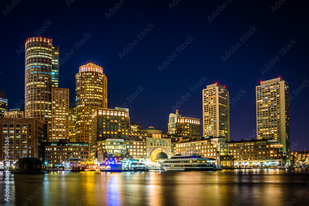 The Boston skyline and Rowes Wharf at night, seen from Fort Poin