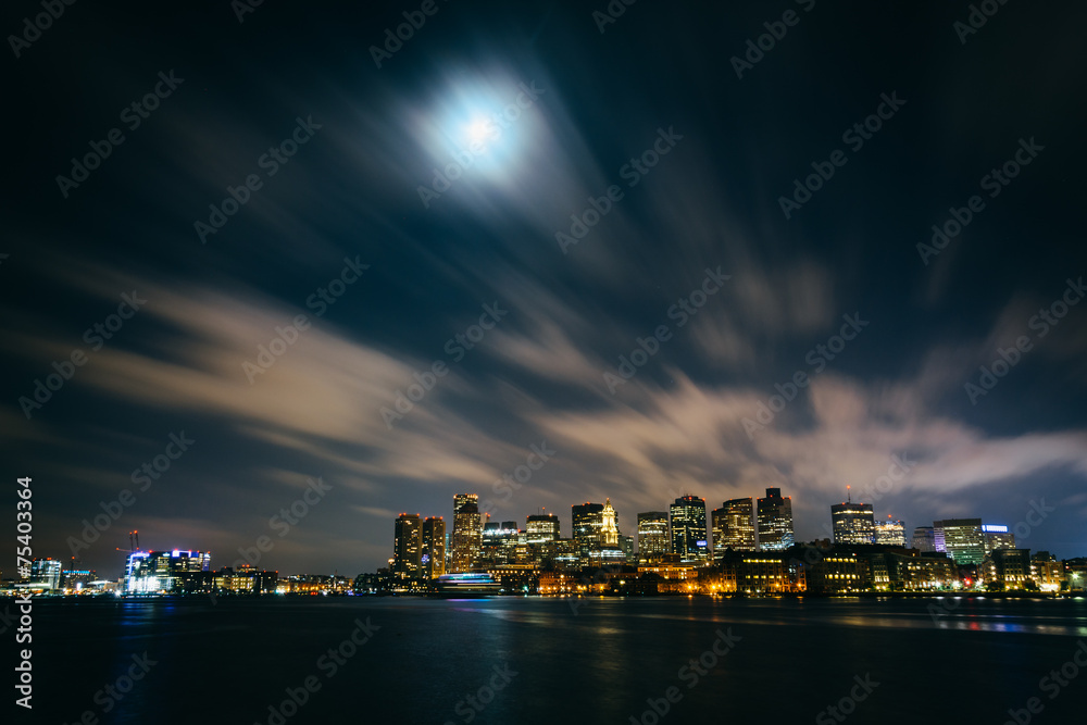 The moon and clouds moving through the sky over the Boston skyli