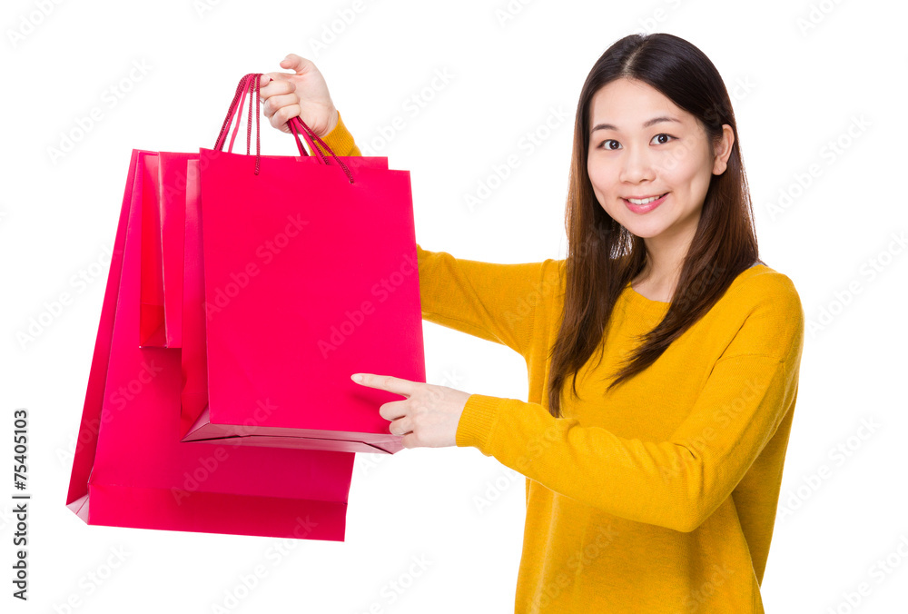 Woman finger point to shopping bag Woman finger point to shopping bag