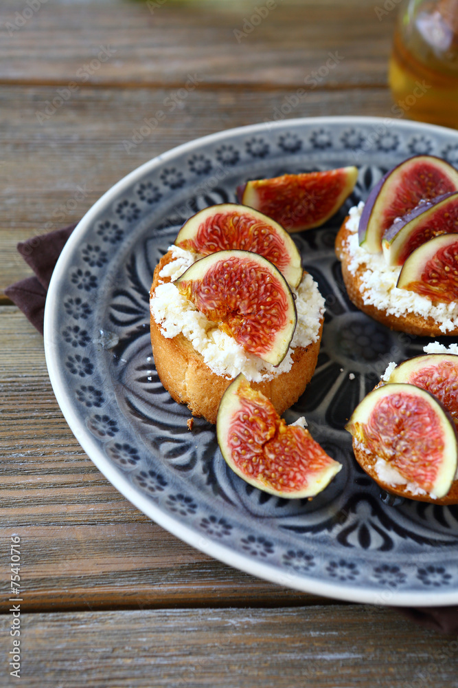 Bruschetta with juicy figs on a plate Bruschetta with juicy figs on a plate