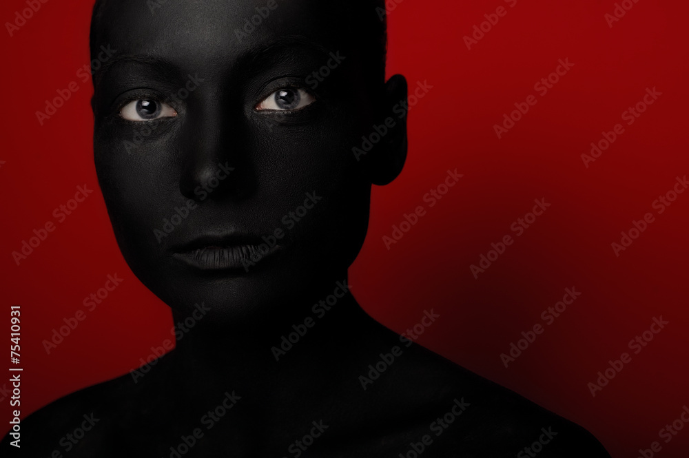 close-up portrait of woman in black paint