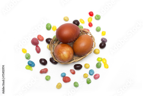 Happy Easter. Colored Easter eggs and candy. Photo.