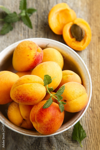 Fresh apricots on metal bowl