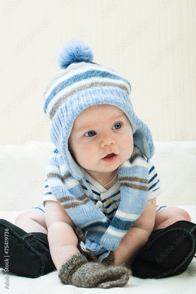 Cute baby boy wearing of warm knitted hat , gloves , Ugg boots Cute baby boy wearing of warm knitted hat , gloves , Ugg boots