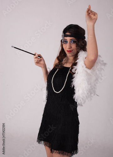 Young sexy girl posing in flapper style dress