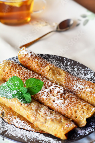 Sweet Crepes With Strawberry Jam With Cup Of Tea.