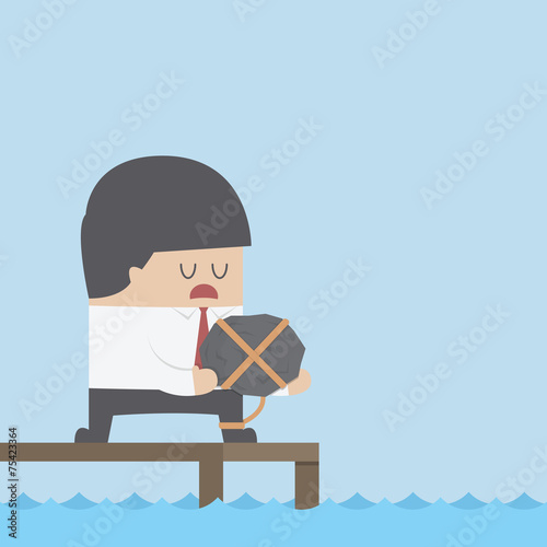Desperate businessman holding the rock and dicide to commit suic
