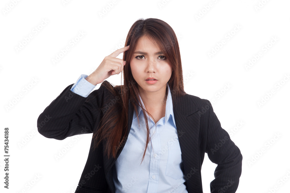 Fed up young Asian businesswoman point to her head Fed up young Asian businesswoman point to her head