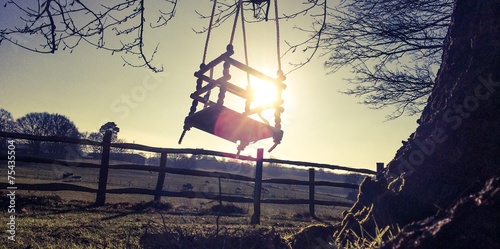 child's swing in sunny winter